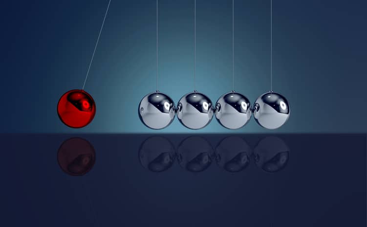 An example of Newton's pendulum, featuring a red chrome sphere about to hit silver chrome sphere, symbolizing clashing due to lack of emotional intelligence.